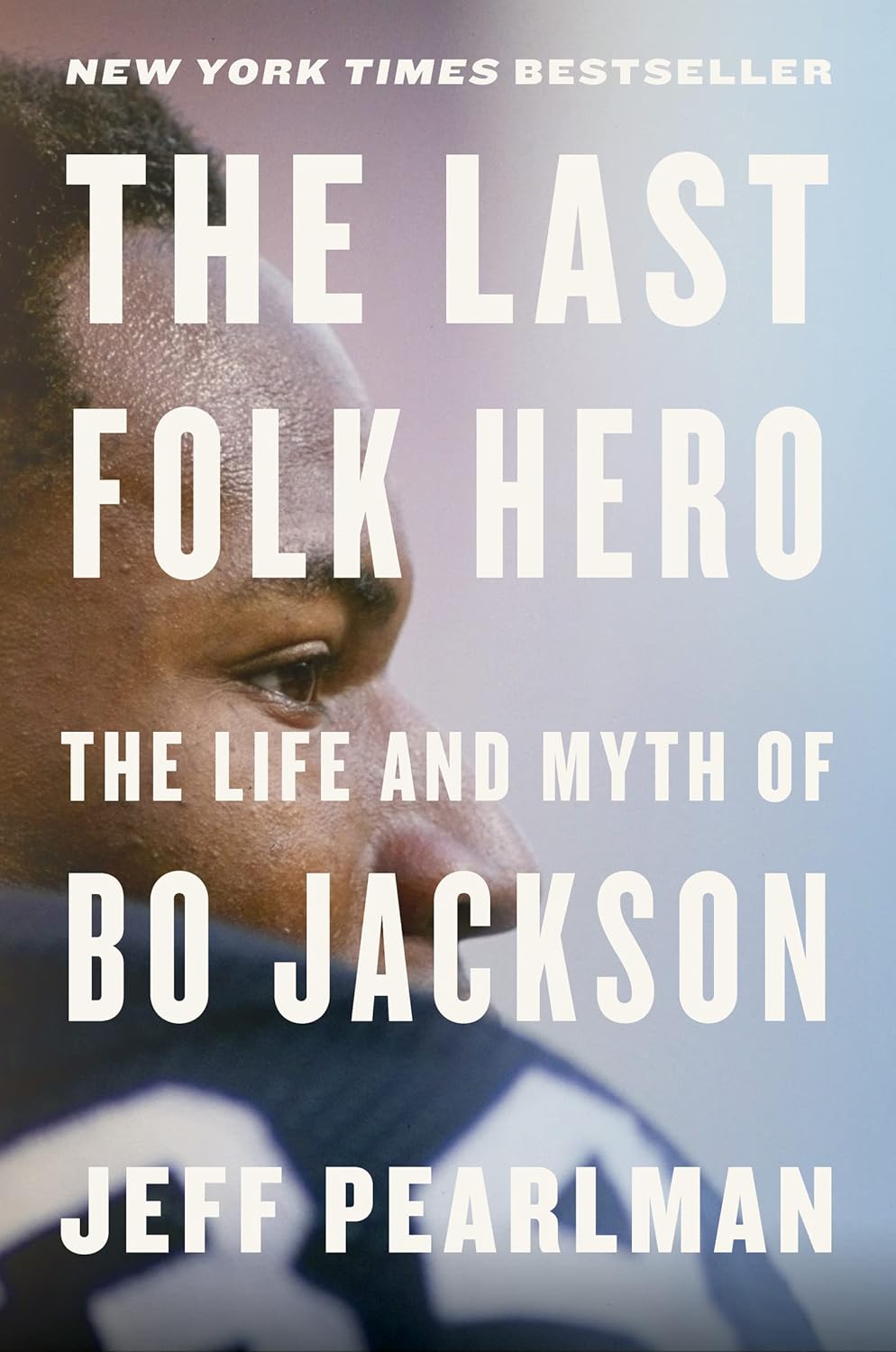 Book cover of 'The Last Folk Hero: The Life and Myth of Bo Jackson' by Jeff Pearlman, featuring a close-up of a person's face.