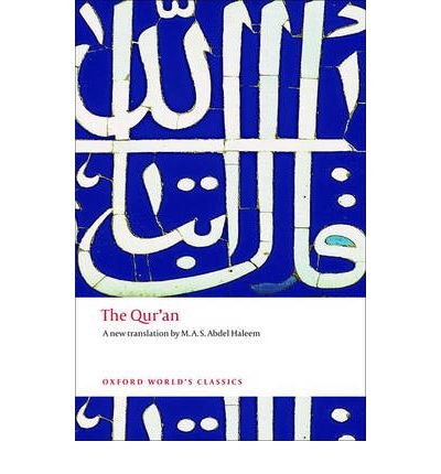 Book cover of 'The Qur'an' with Arabic calligraphy on a blue background