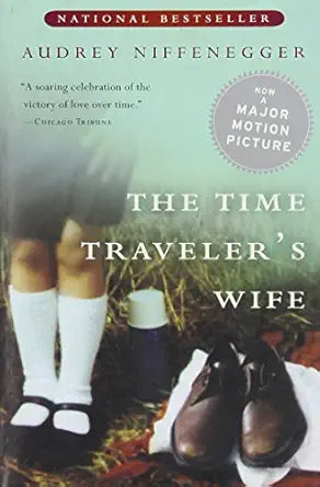 Book cover of 'The Time Traveler's Wife' with a photograph of two people in shoes on grass.
