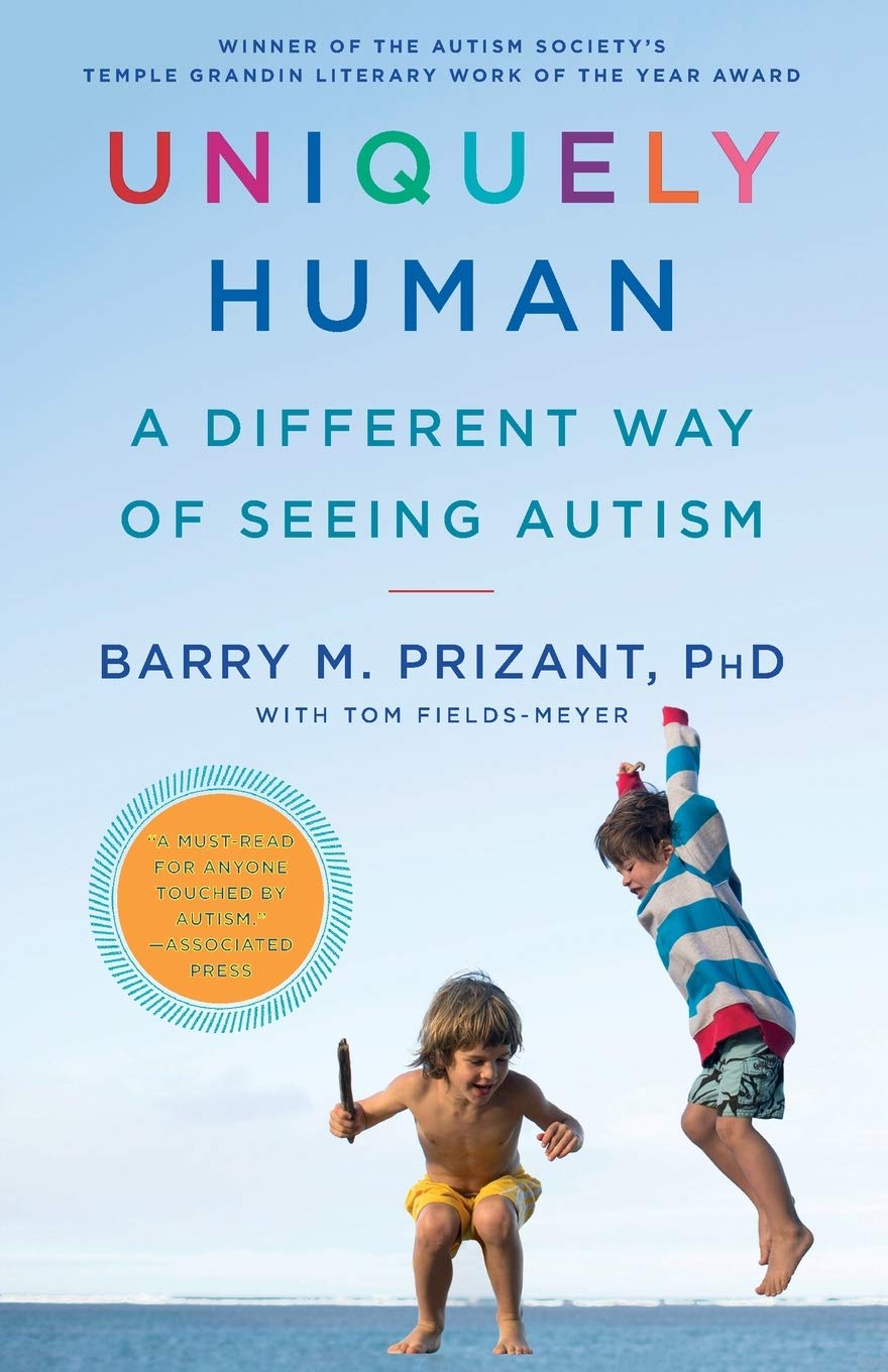 Book cover of 'Uniquely Human: A Different Way of Seeing Autism' with two children playing on a beach.