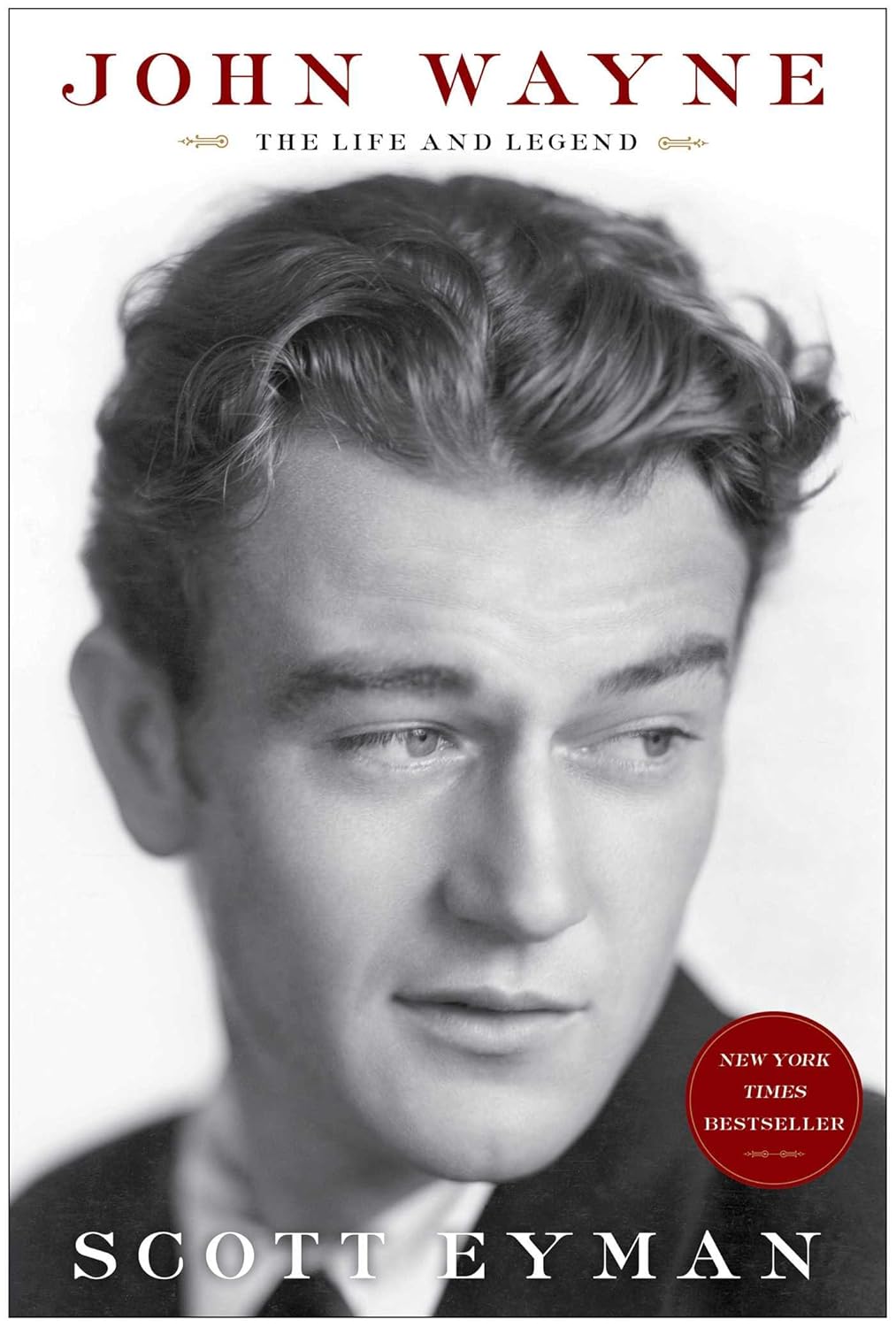 Book cover of 'John Wayne: The Life and Legend' by Scott Eyman with a black and white portrait of John Wayne.