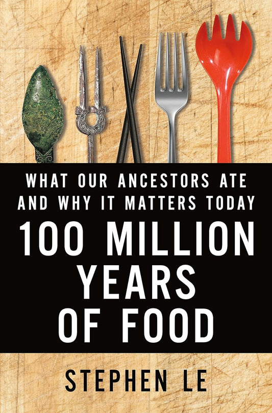 Book cover of '100 Million Years of Food' with vintage utensils on a wooden background