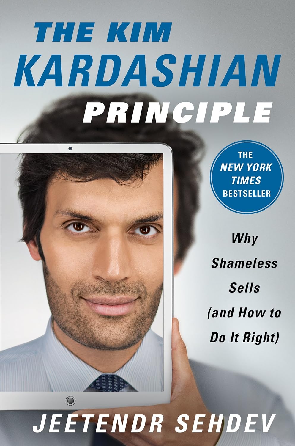 Book cover of 'The Kim Kardashian Principle' by Jeetendr Sehdev with a man holding a tablet displaying his face.