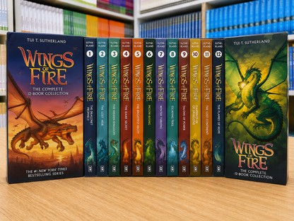 The complete 12-book collection of 'Wings of Fire' by Tui T. Sutherland, displayed upright on a wooden table with bookshelves in the background.